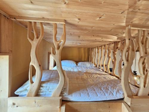 a bed in a room with wooden ceilings at Jeju Nova Pension in Jeju