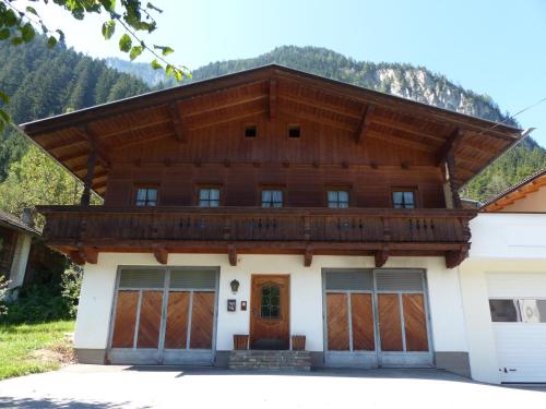 a house with a wooden roof at Chalet Walchenhof in Mayrhofen