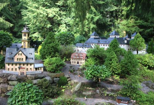 a model of a house and a tower in a garden at Erzgebirgsferien in Olbernhau