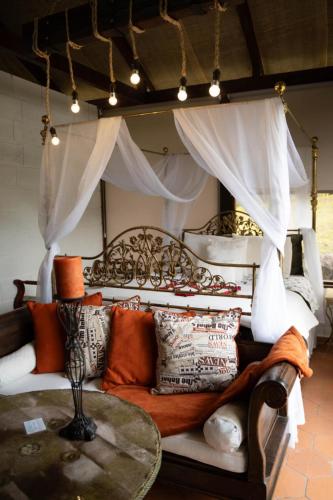 a living room with a couch and a table at Villa Nathalie, 2 bedrooms, jacuzzi, king size bed, hammock, FIREPLACE in Chicán
