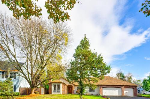 a house with a tree in the yard at Near Shops and Cafes Beaverton Haven with Luxe Decor! in Beaverton
