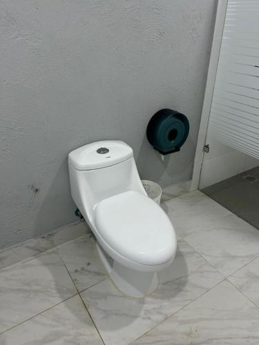 a bathroom with a white toilet in a room at Hotel Hannabi in Boca Chica
