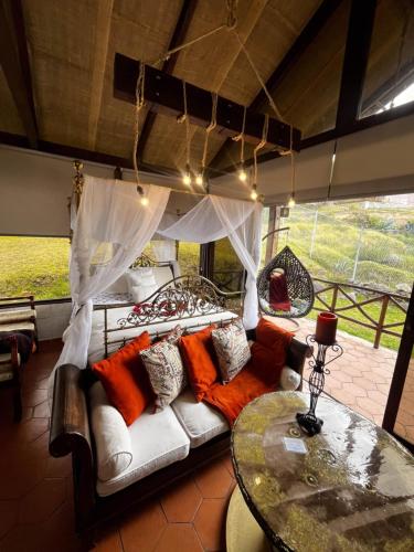 a living room with a couch and a table at Villa Nathalie, 2 bedrooms, jacuzzi, king size bed, hammock, FIREPLACE in Chicán