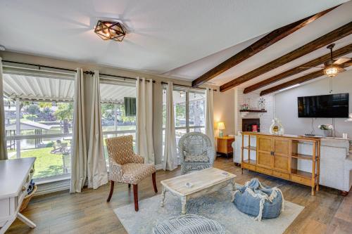 a living room with a tv and a table and chairs at Waterfront Retreat with Hot Tub in Gun Barrel City! in Gun Barrel City
