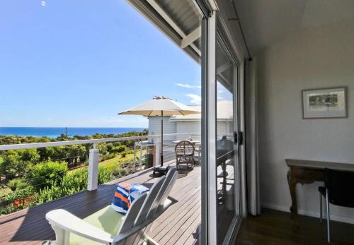 a balcony with a view of the ocean from a house at The Whale Lookout, Eagle Bay in Dunsborough