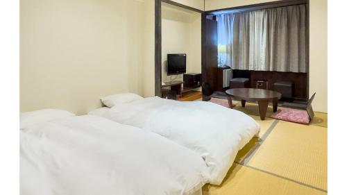 Ένα ή περισσότερα κρεβάτια σε δωμάτιο στο Hotel Shosenkaku Romankan