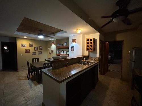 a kitchen with a table and a dining room at Beach house between Tamarindo and Avellanas in Santa Cruz
