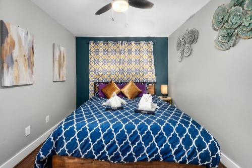 a bedroom with a blue bed with two pillows at 1BR King Bed Apt, Free Park Close to Medical Center in Houston
