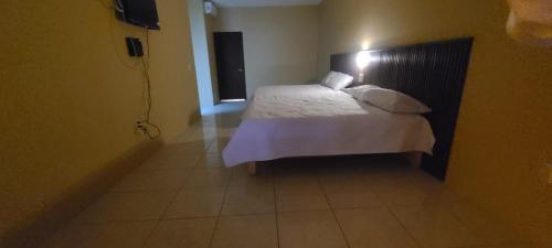 a bedroom with a bed with a light on it at Departamentos los 7 Nogales in Tequila
