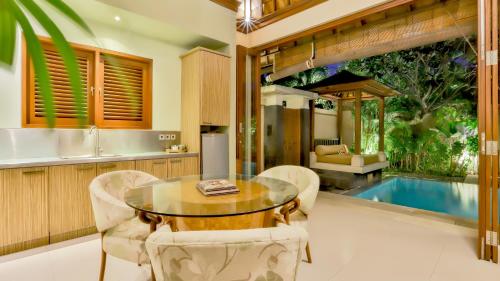 a kitchen and dining room with a table and chairs at DISINI Luxury Spa Villas-CHSE Certified in Seminyak