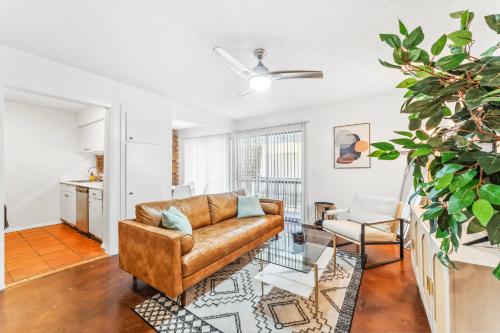 a living room with a couch and a table at Heart of SoCo 2BR and 1BR King Suites with Free Parking, Pool, and Laundry Center in Austin