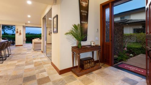 a hallway of a home with a entry way with a table at COCONUT TELEGRAPH Rejuvenating 3BR Villages Home Near Recreation Center in Waikoloa
