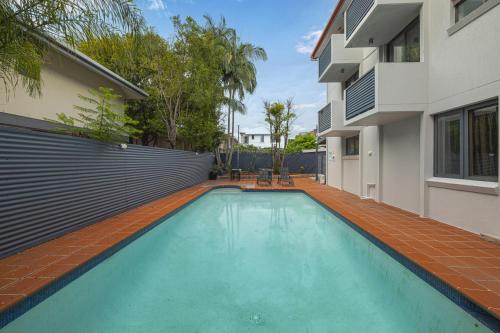 a swimming pool in the backyard of a house at Asraport Motel in Brisbane
