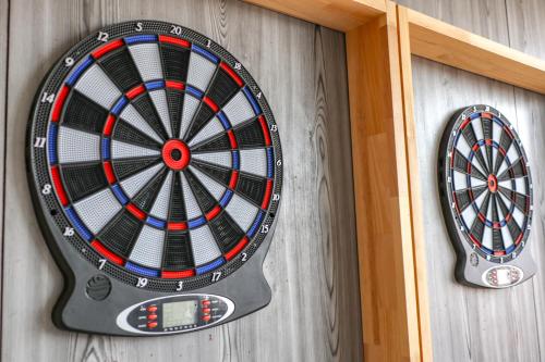a dart board hanging on a wall at Alba HOTEL & Glamping in Nishinoura