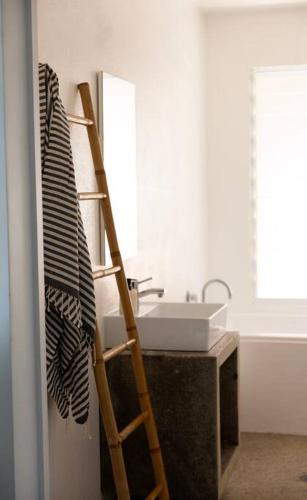 a bathroom with a ladder next to a sink at THE BEACH HAVENS in Emerald Beach