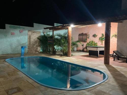 a swimming pool in the middle of a patio at Casa Flor Morena in Aracati