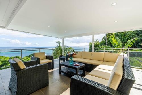 a living room with couches and a table at Domaine To'a Hotu in Tohautu