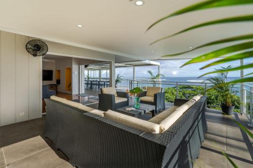 a living room with a couch and chairs on a balcony at Domaine To'a Hotu in Tohautu