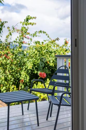 a pair of chairs and a table on a porch at Domaine To'a Hotu in Tohautu