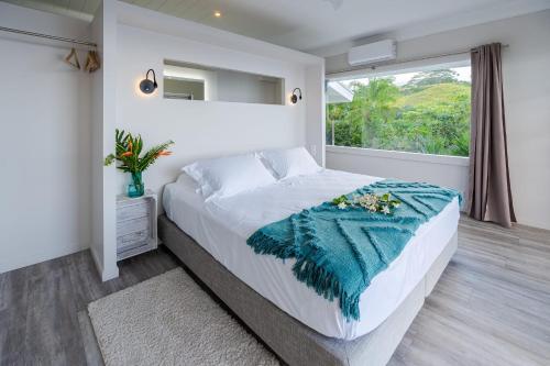 a bedroom with a large bed and a window at Domaine To'a Hotu in Tohautu