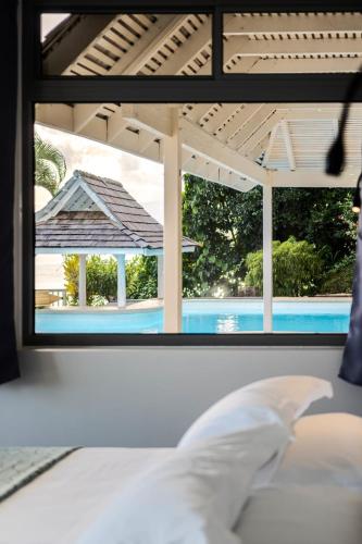 a view of a pool from a bedroom window at Domaine To'a Hotu in Tohautu