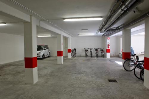 a parking lot with cars and bikes in a building at Residence La Nave in Senigallia
