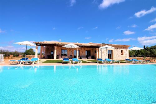 a villa with a swimming pool in front of a house at Ferienhaus Son Pieres Nou in Llucmajor