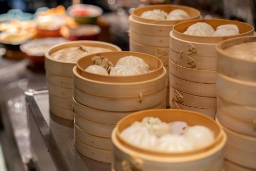 a bunch of bowls filled with food on a counter at Crystal Hotel Shanghai Lujiazui Oriental Pearl Tower in Shanghai