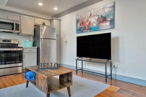 a kitchen with a tv and a table in a room at Bright and Modern Loft in Louisville # 208 in Louisville
