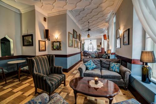 a living room with couches and a table at Małopolanka & Spa in Krynica Zdrój
