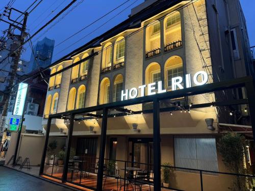 a hotel with a sign on the side of a building at Hotel RIO新宿 in Tokyo
