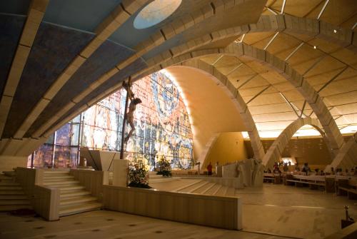 a building with a large stained glass window and stairs at Hotel Immagine in San Giovanni Rotondo
