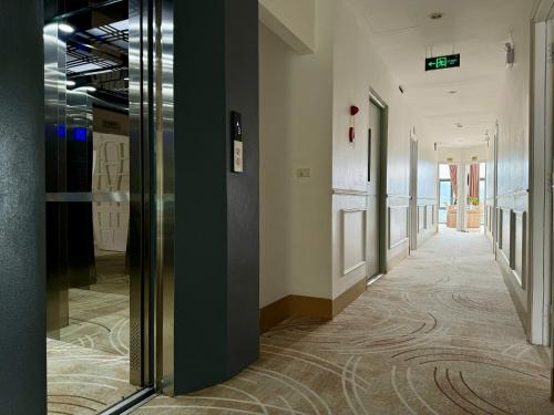 a hallway in a building with a door open at Cong Fu Hotel in Bắc Hà