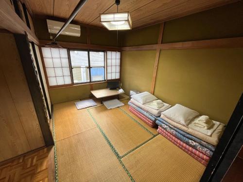 Postel nebo postele na pokoji v ubytování ふる里 Mt Fuji Inn Furusato