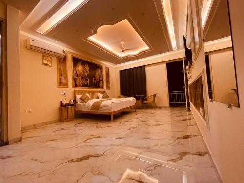 a living room with a bed and a room with marble floors at Paradise Woodland Resort Chintpurni in Bharwain