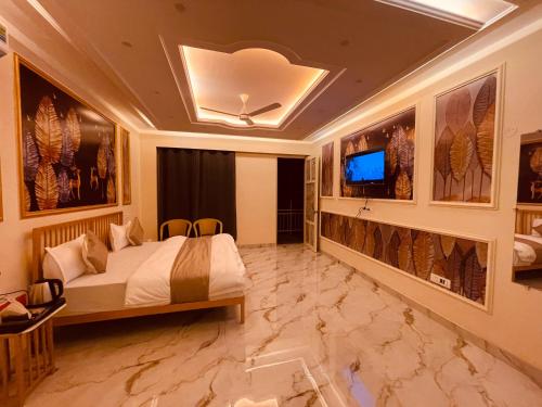 a hotel room with a bed and a tv at Paradise Woodland Resort Chintpurni in Bharwain