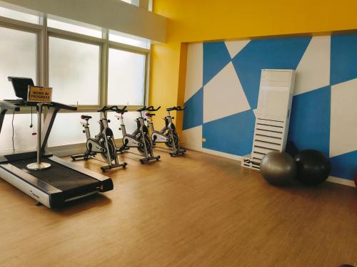 a gym with bikes lined up in a room at Tessa's Place Staycation 4FI in Jalang