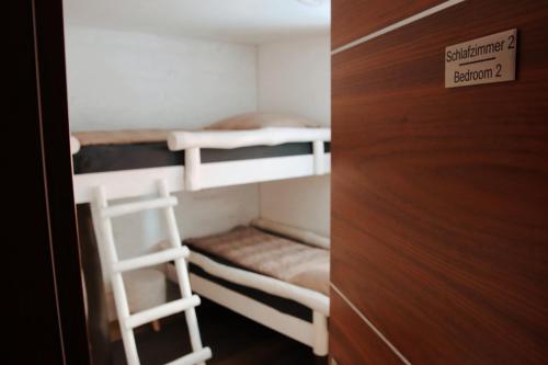 a room with two bunk beds and a ladder at Liebevolles renoviertes Haus anno 1858! in Thüringen