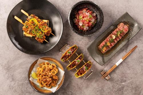 a table with plates of food and a plate of food at Dubai Marriott Harbour Hotel And Suites in Dubai