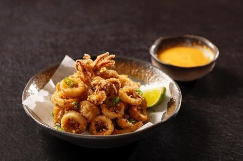 a bowl of shrimp and a bowl of dipping sauce at Dubai Marriott Harbour Hotel And Suites in Dubai