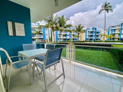a balcony with a table and chairs and palm trees at paradise close to the beach pool free parking,wifi- punta cana in Punta Cana