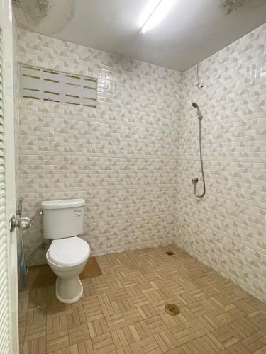a bathroom with a toilet and a shower at SHERRY'S Guest House in Patong Beach