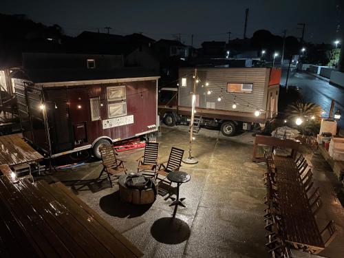 an rv and a truck parked in a parking lot at night at 絶景シーサイドナハマ-BBQとサウナ-海まで徒歩60秒w in Yokosuka
