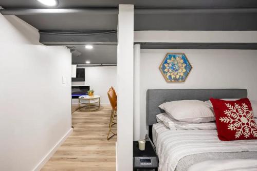a bedroom with a bed with a red pillow at Romantic Hideout 1Bedroom Lower Level in Stamford