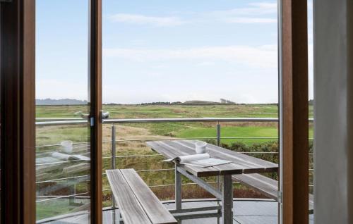a balcony with a bench and a view of a field at Holiday Home Vestergade Rømø Iii in Rømø Kirkeby