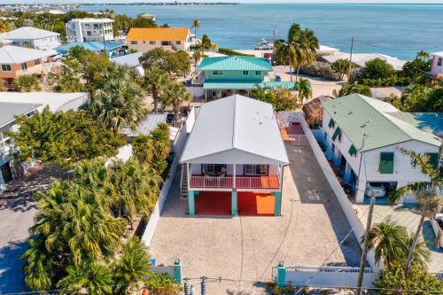 an aerial view of a town with houses and the ocean at Tiki Time! Pool-tiki Hut-kayaks-grill-ocean View! in Marathon