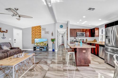 a kitchen and living room with a couch and a table at Tiki Time! Pool-tiki Hut-kayaks-grill-ocean View! in Marathon