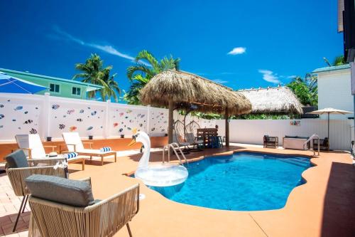 a swimming pool with a swan on a patio at Tiki Time! Pool-tiki Hut-kayaks-grill-ocean View! in Marathon
