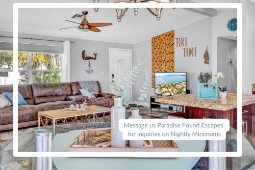 a living room with a couch and a table at Tiki Time! Pool-tiki Hut-kayaks-grill-ocean View! in Marathon