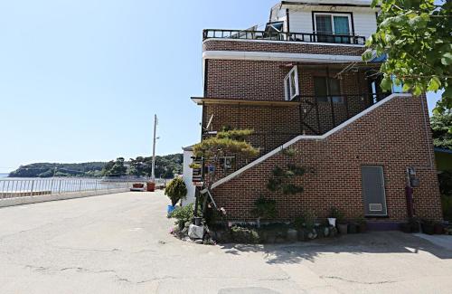 a brick building with a staircase on the side of it at Taean Gaetyeowool Pension in Taean